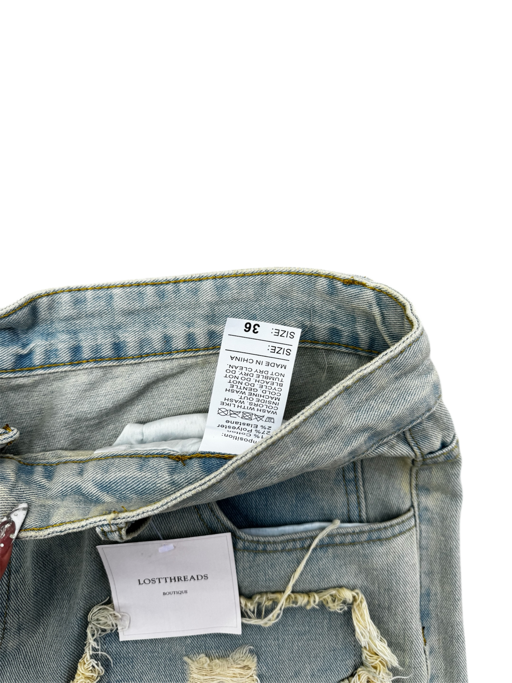 Cream / light wash distressed denim jeans