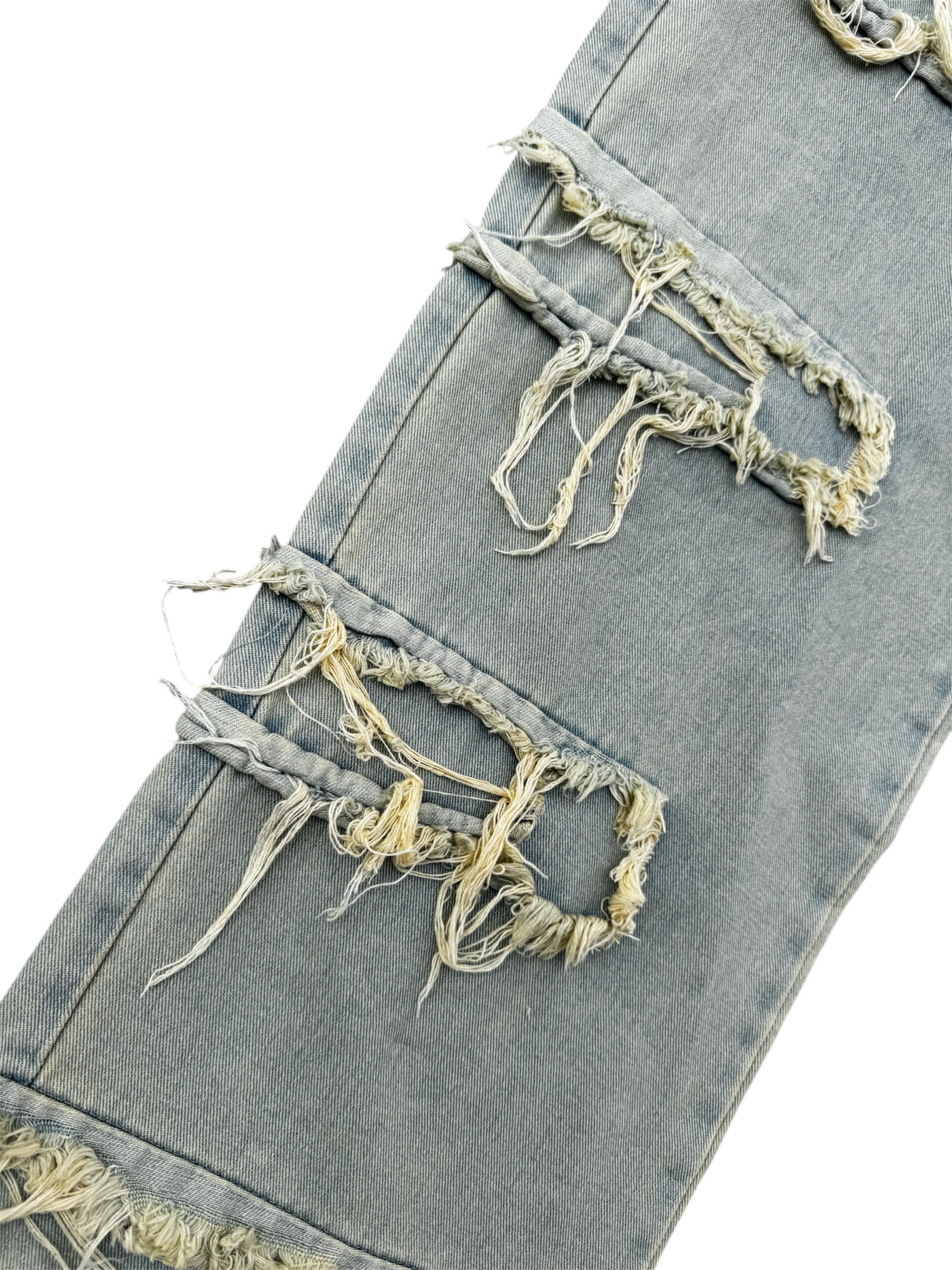 Cream / light wash distressed denim jeans